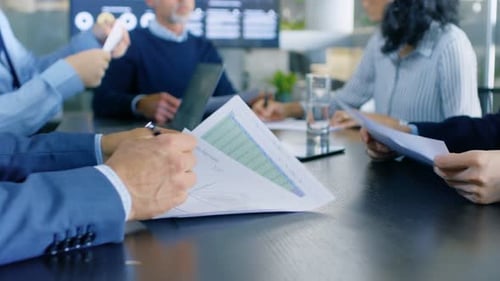 Business Meeting with Charts and Graphs Discussion