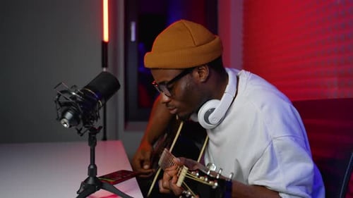 Man Playing Guitar in Recording Studio at Home