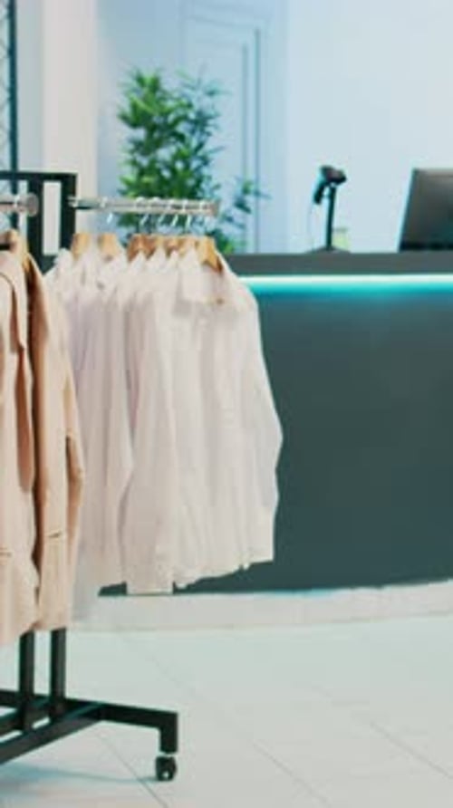 Vertical Video Empty Clothing Store Filled with Racks and Hangers
