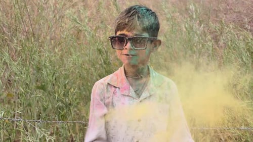 Happy Child Covered in Holi Festival Dye