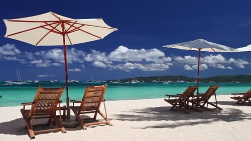 Sun Umbrellas and Beach Chairs on Tropical Beach Summer Vacation