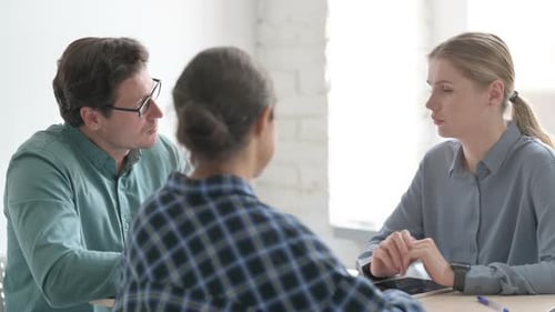 Close Up of Young People Discussing Work During Meeting