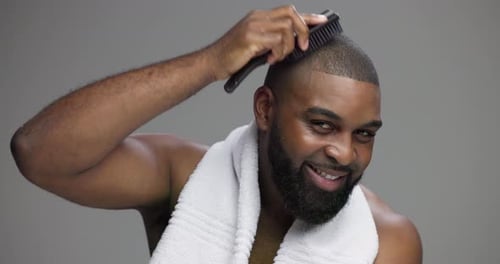 Brush, beauty and face of black man in studio for shower, smile and grooming