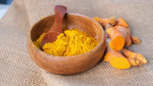 Turmeric Powder and Roots Curcuma Longa Kurkuma Panning Turmeric on Black Background Top View Close