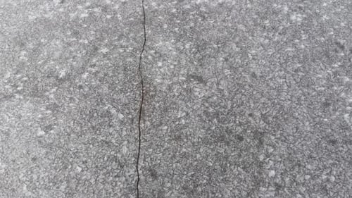 Cracked ice icy frozen lake crack top view from above, Aerial