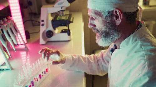 Scientist Analyzing Test Tubes in Modern Laboratory