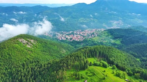 View From Rock to Town of Smolyan with Meadows for Cattle Walking and Houses Between Mountain Range