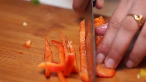 Slicing Fresh Red Bell Pepper with Sharp Knife