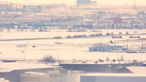 Snowplows and crews removing snow from runway at Toronto, Canada airport