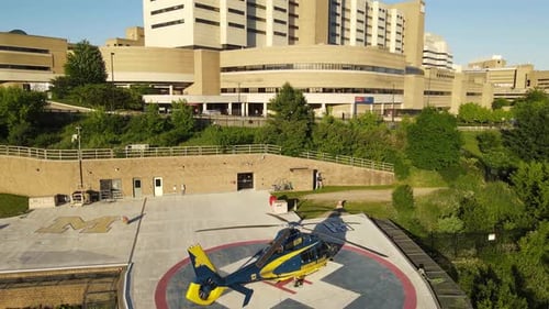 Modern helicopter near University of Michigan Hospital, aerial ascend view