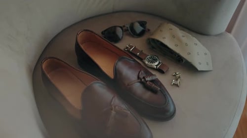 Men's Fashion Accessories Displayed on Gray Chair