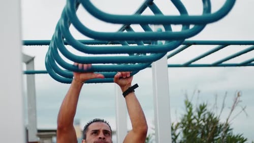Man Doing Pull Ups Across Monkey Bar