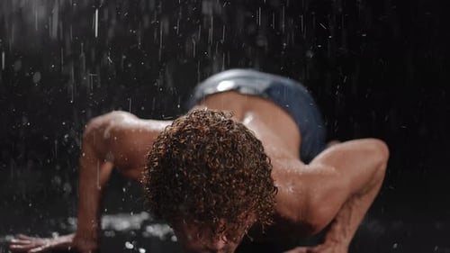 Athletic Man Doing Push Ups in the Rain