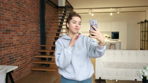 Joyful Young Woman Captures Selfie in Chic Urban Loft RED VRAPTOR 8K RAW