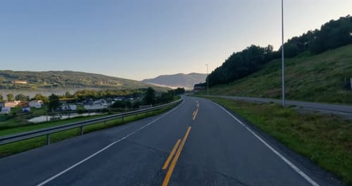 Driving a Car on a Road in Norway.