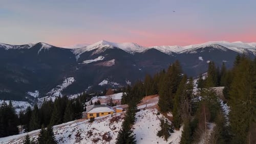 Breathtaking Snowy Mountain Landscape at Sunset Serene Winter Scenery with Pine Trees and Remote
