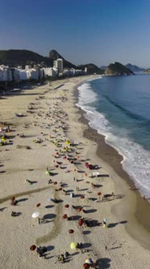 Drone Over Copacabana Beach Colorful Umbrellas Blue Ocean Skyscrapers