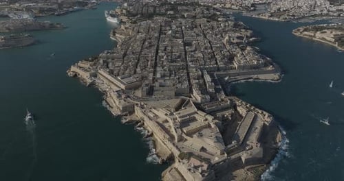 Aerial view of historic fortress city and coastline by the sea, Valletta, Malta.