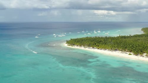 Panorama of white sand beaches and luxury yachts anchored off the coast of Don\minican Republic, aer