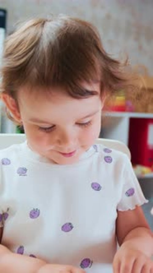 Toddler Plays with Clay with Woman Indoors
