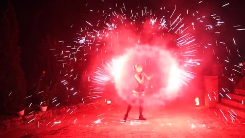 Fire Performance Show Red Sparks at Night Female Artist Spins Sparklers at the Street Fire Dancer