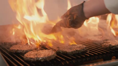 Barbecue-Burger mit Rind- oder Schweinefleisch für gegrillte Hamburger. Fleisch am offenen Feuer kochen.
