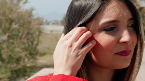 Woman Wearing Earrings Close Up in Urban Setting