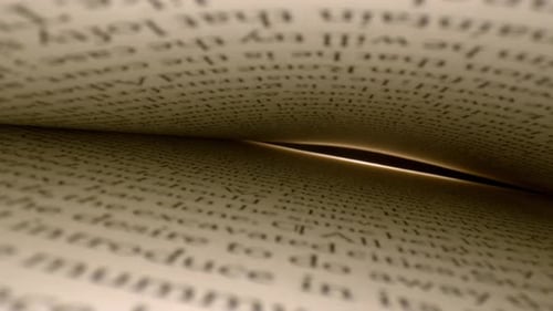 Inside a book, pages on top and bottom, spotlight at far end of pages visible highlighting page edge