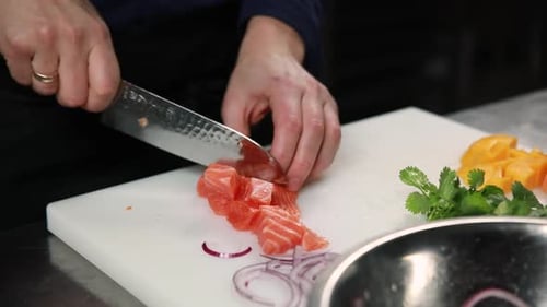 chef prepares a salmon dish in the kitchen. Close-up shots