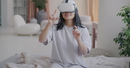 Young Adult Wearing VR Headset Gesturing