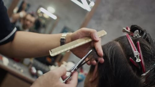 Barber Cuts Hair With Scissors and Comb