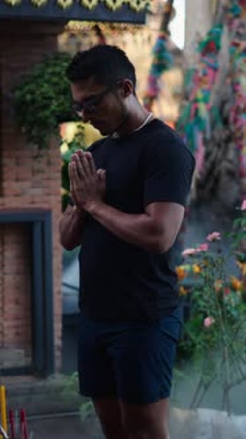 Latino Boy with His Hands Clasped at Chest Level Offering Respect to the Buddha
