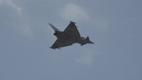 Sleek Fighter Jet Soaring Through a Blue Sky