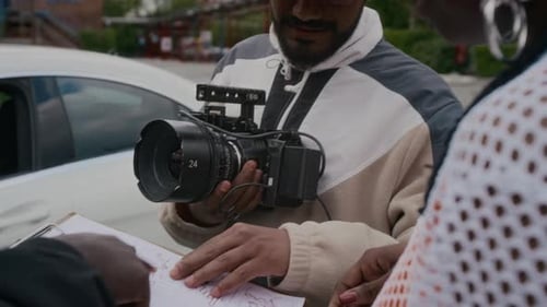 Film Crew Discussing Production in an Urban Setting