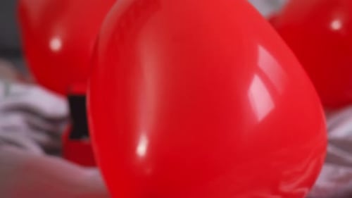 Heart Balloons and Champagne Glass on Bed