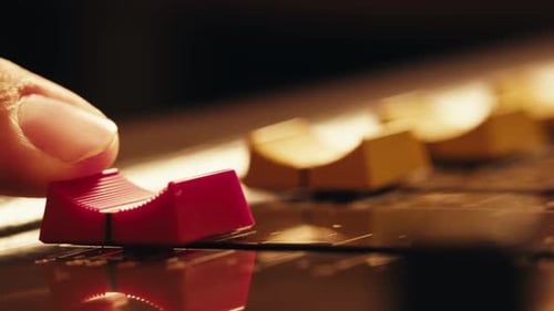 Music Studio Close Up Close Up Hands Shot of Sound Engineer Using Mixing Console Remote Control for
