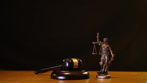 Gavel and Statue of Justice on Wooden Table