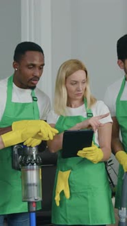 Attractive Positive Multiethnic Young Men and Women From Cleaning Service Standing in the Middle of
