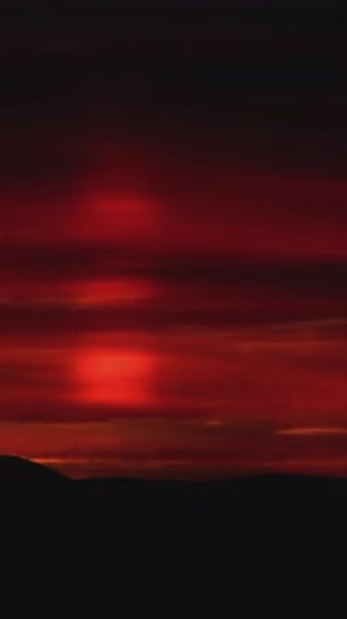 Majestic Sunset Over Distant Mountains