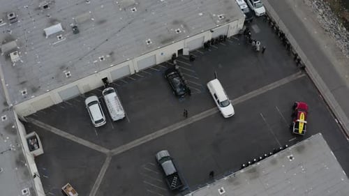 Aerial drone spirals upwards outside of a funeral. Sad, tragic.