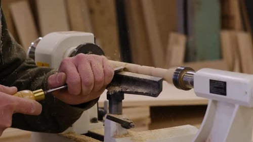 Close Up Carpenter at Workshop Polishes Wooden Board with a Electric Orbital Sander Woodwork and