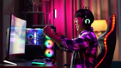 Excited Young Man Playing Video Game at Home