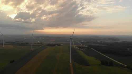 Aerial view of wind turbines generating power during beautiful morning sunrise following a early mor