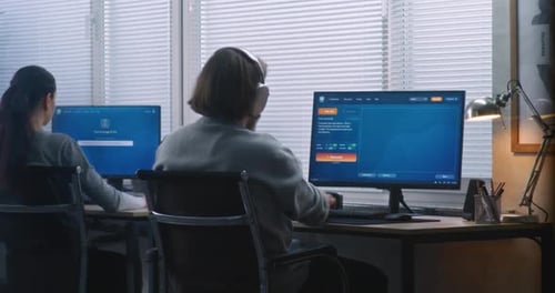 Two Diverse Workers Using AI Generator on Computers in Office