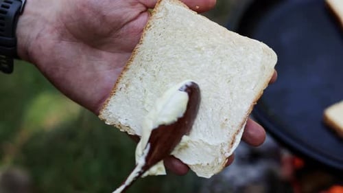 Spreading Bread with Wooden Spoon Close Up