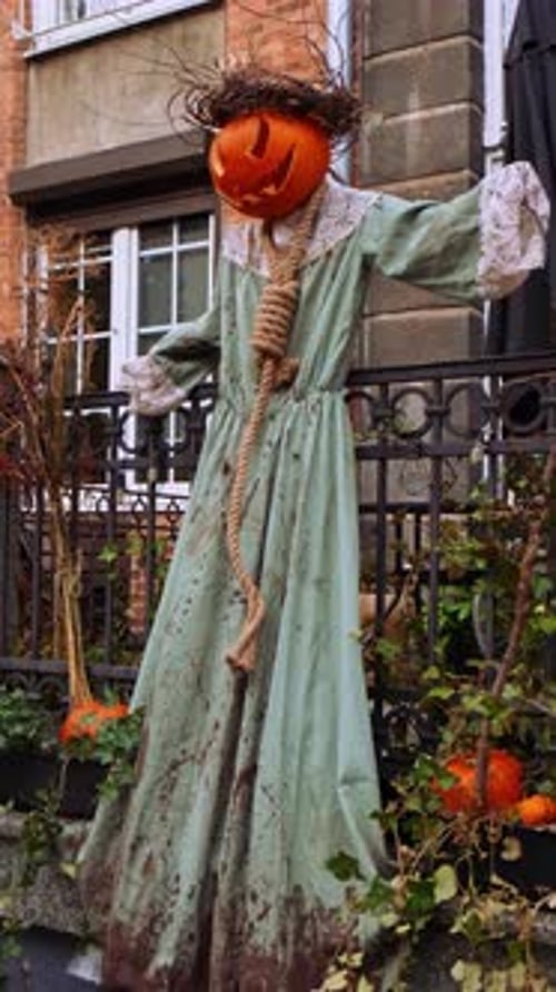 Halloween scarecrow decoration with pumpkin head and rope