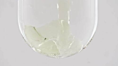 Clear Liquid Poured into Glass Container