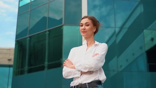 Confident Businesswoman Standing Outside Modern Office Building
