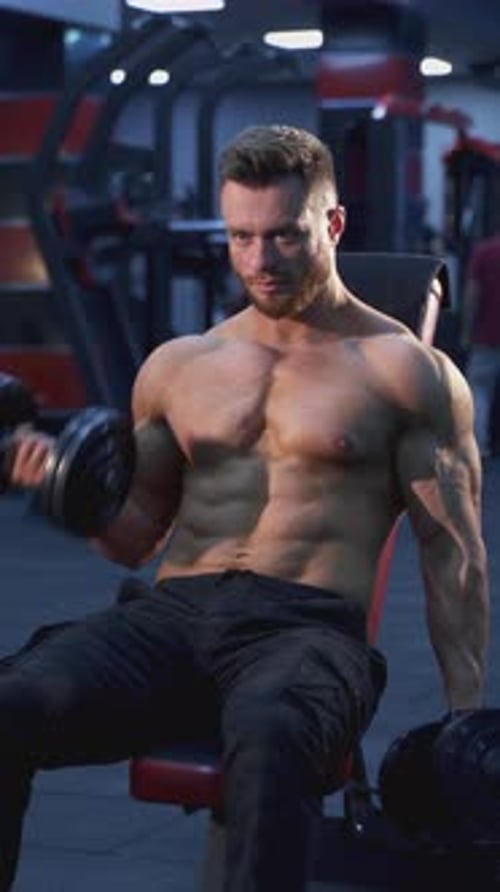 Professional bodybuilder exercising in gym.