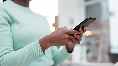 Woman, hands and typing on smartphone in home, reading social media notification